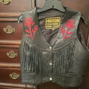 Biker style leather vest with fringe, embossed rose and side grommets.
